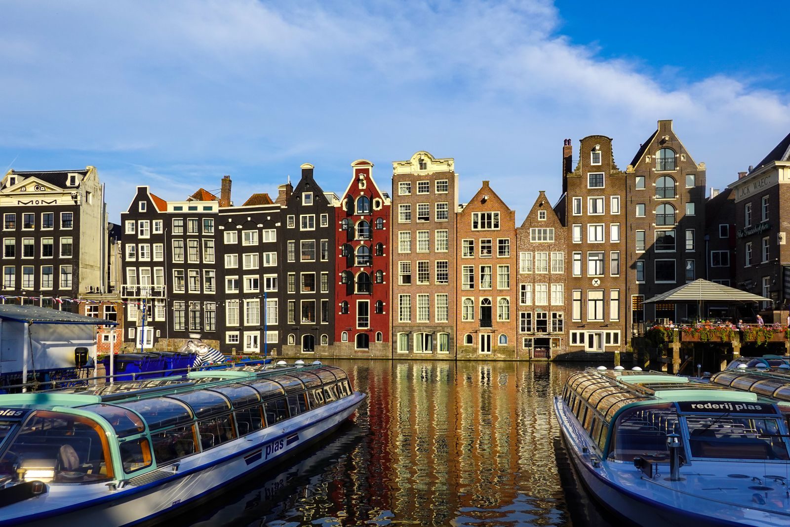 Colourful canal houses and boats in Amsterdam