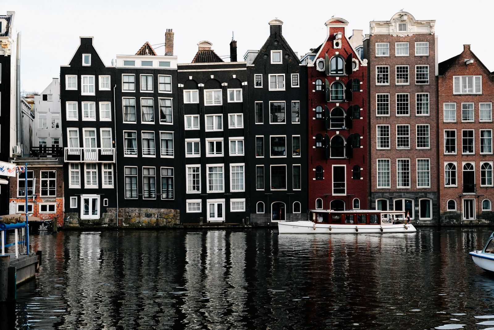Gabled canal houses reflected in an Amsterdam canal.