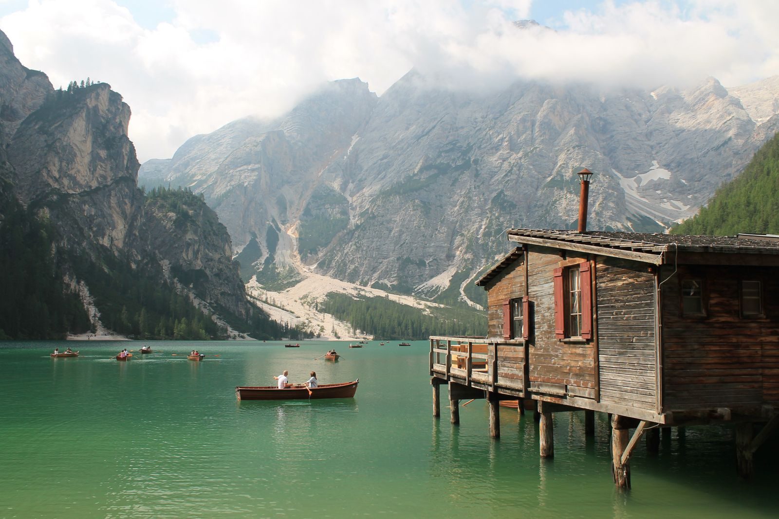 Wooden boathouse and boats on Lago di Braies