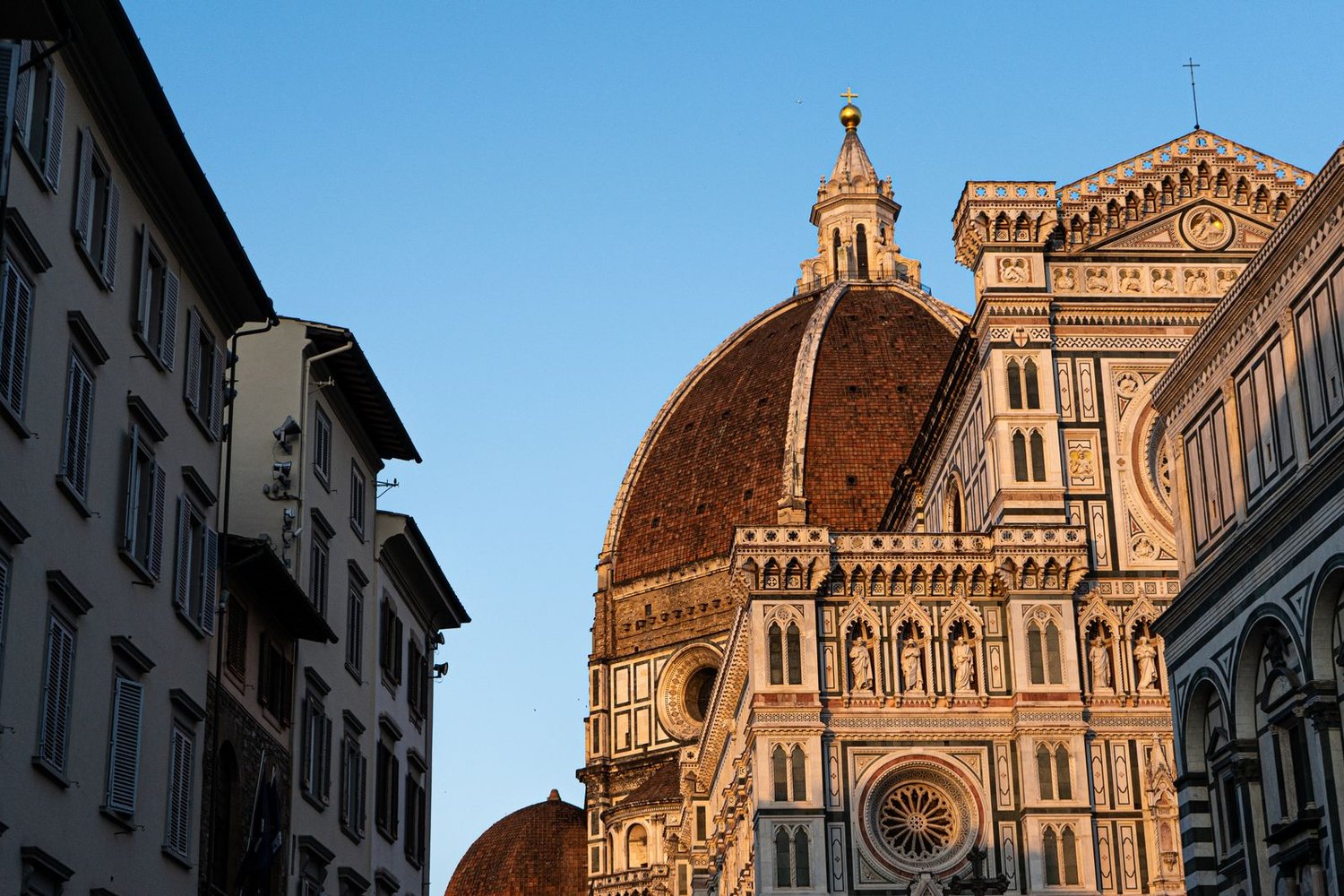 The dome of Florence Cathedral rising above the city in warm light.