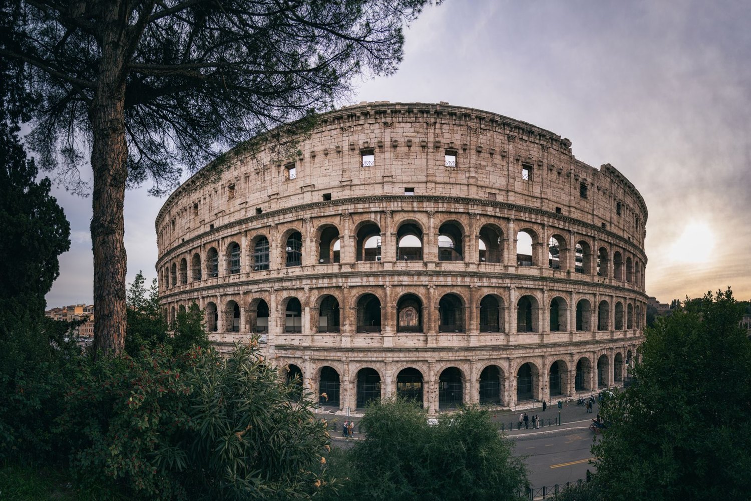 The Colosseum in Rome under a warm evening sky.