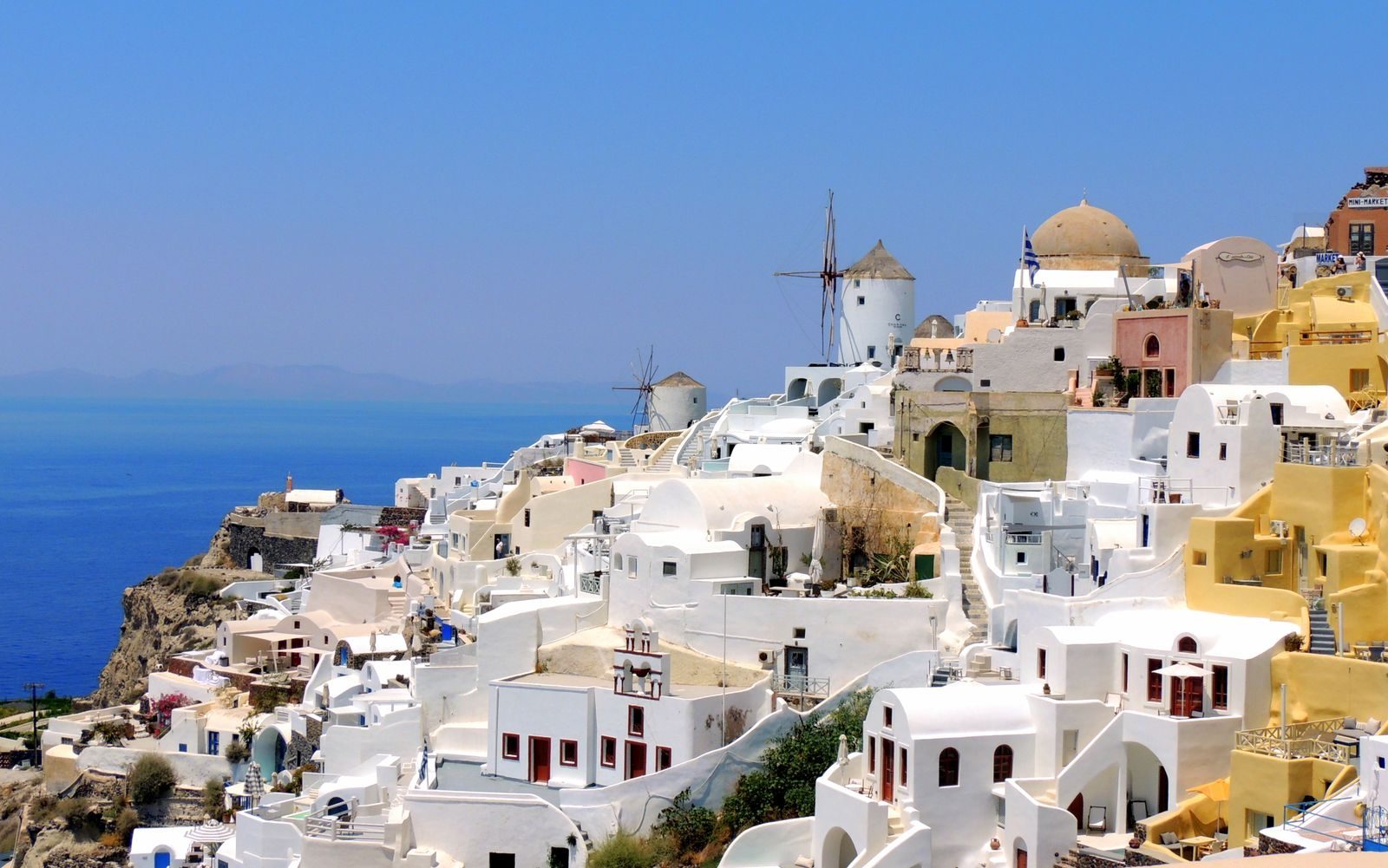 Oia village in Santorini above the blue sea